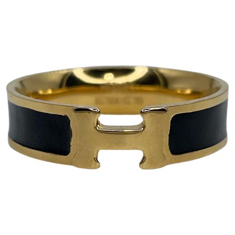 black and gold hermes ring